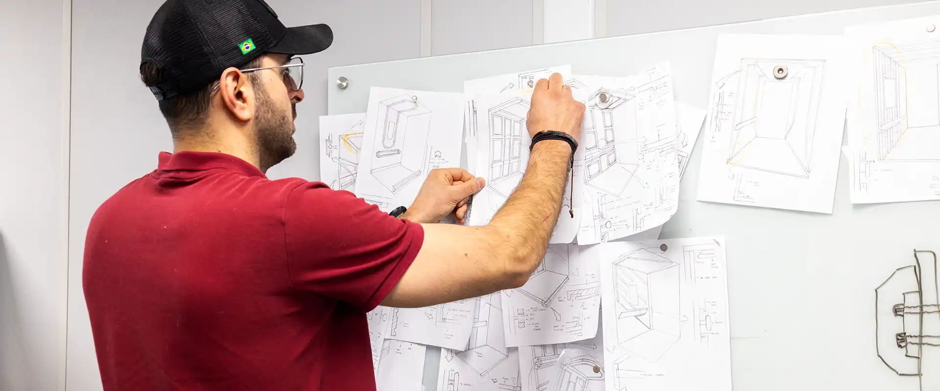 Savaria staff member putting up schematics for products on board