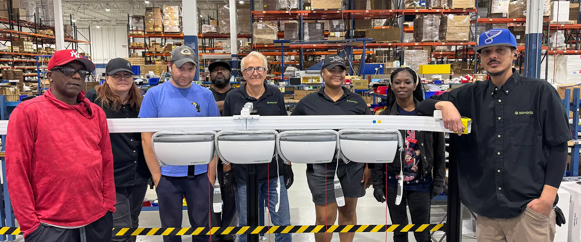 Savaria team taking a picture next to M-series ceiling lift