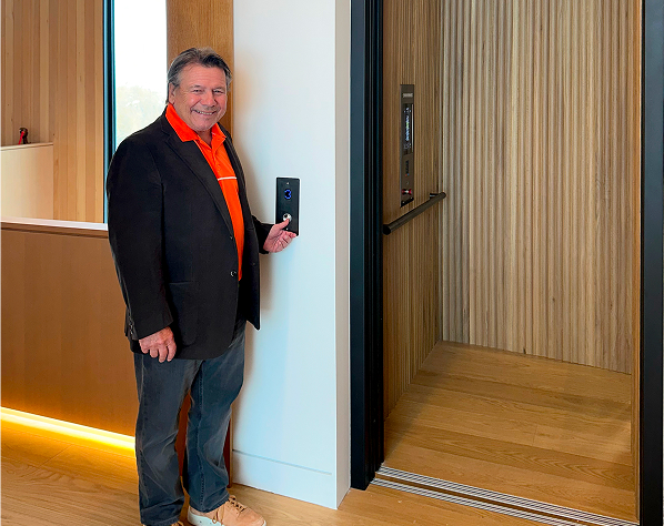 Marcel Bourassa pressing button to Eclipse home elevator